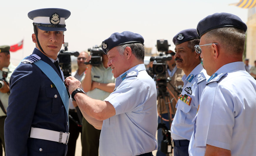 His Majesty King Abdullah, the Supreme Commander of the Jordan Armed Forces-Arab Army, presents a cadet at the King Hussein Air College with his wings during a graduation ceremony on Monday (Photo courtesy of Royal Court)